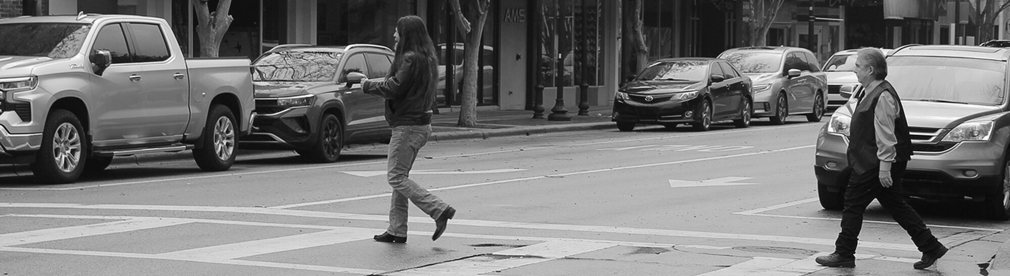 Robbie and Rich crossing a street in a crosswalk.